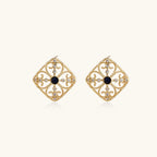Gold filigree stud earrings with navy lapis lazuli center stone and mother-of-pearl accents in ornate quatrefoil design