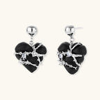 Dark ebony wood heart charms wrapped in intricate silver chains with crystal accents, shown as matching earrings and necklace set.