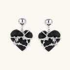 Black heart-shaped wood earrings with decorative silver chains and crystal accents hanging from silver ball studs